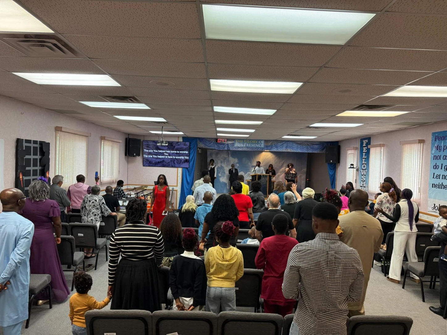 Congregation worshipping with hands raised during a Sunday service at Destiny Int'l Christian Assembly in Yorkton, Saskatchewan